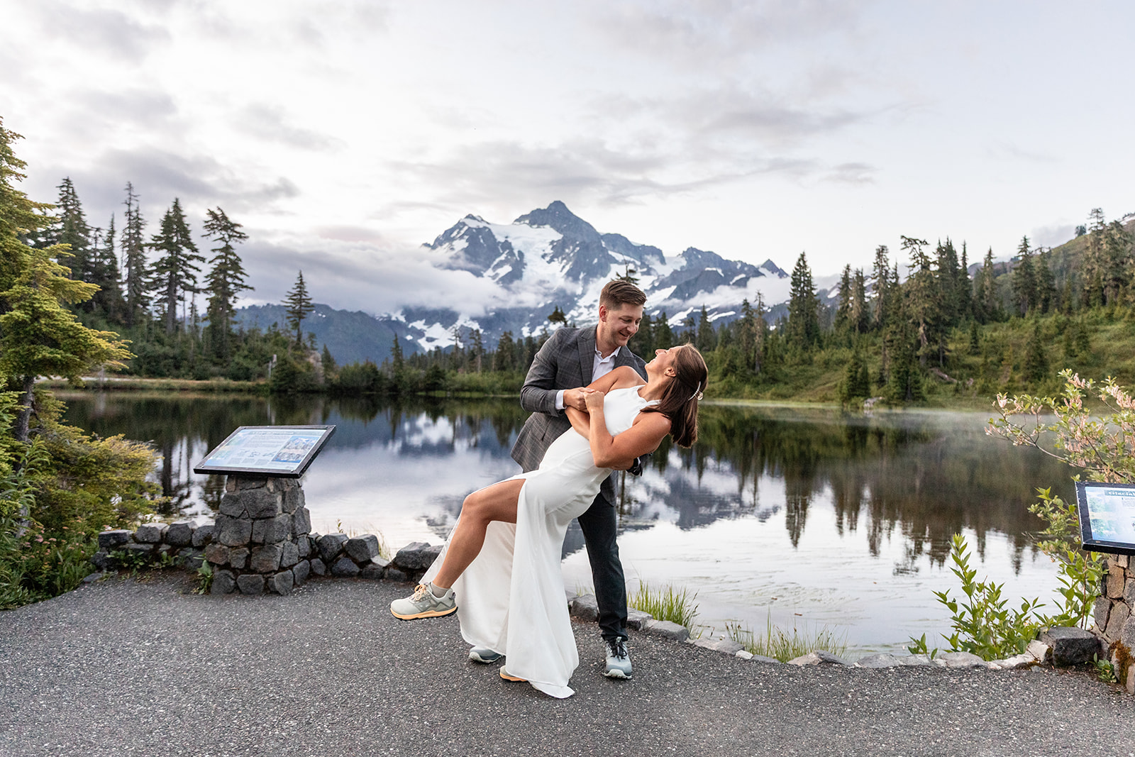 Couple dancing with mountain reflection on a lake in the background in Mount Baker area on their elopement day